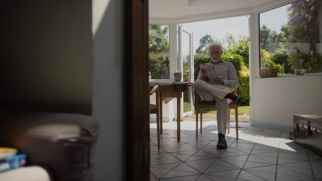 Homeowner Greg reading newspaper in the kitchen of his house